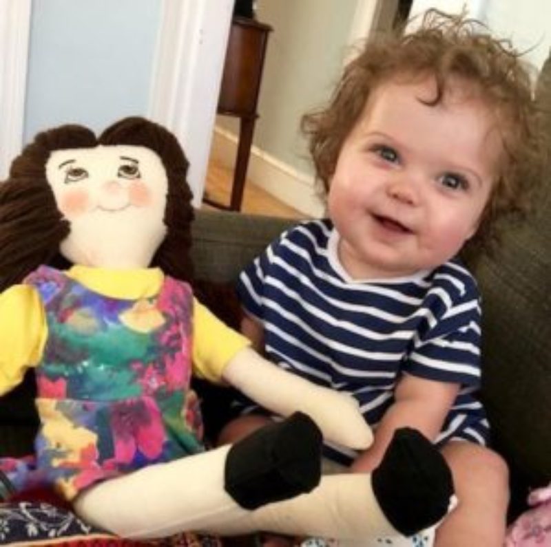A happy photo of baby Millie and her smiling doll