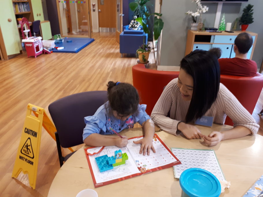 A volunteer helps a child with homework