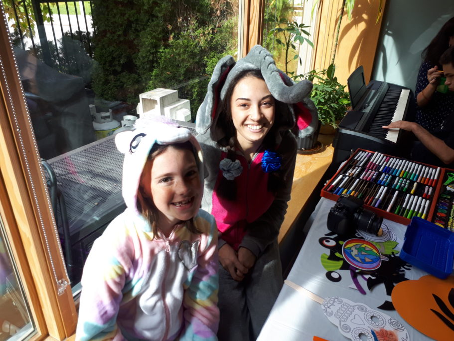 Young people engage in dress-up and craft activities at Emily’s House
